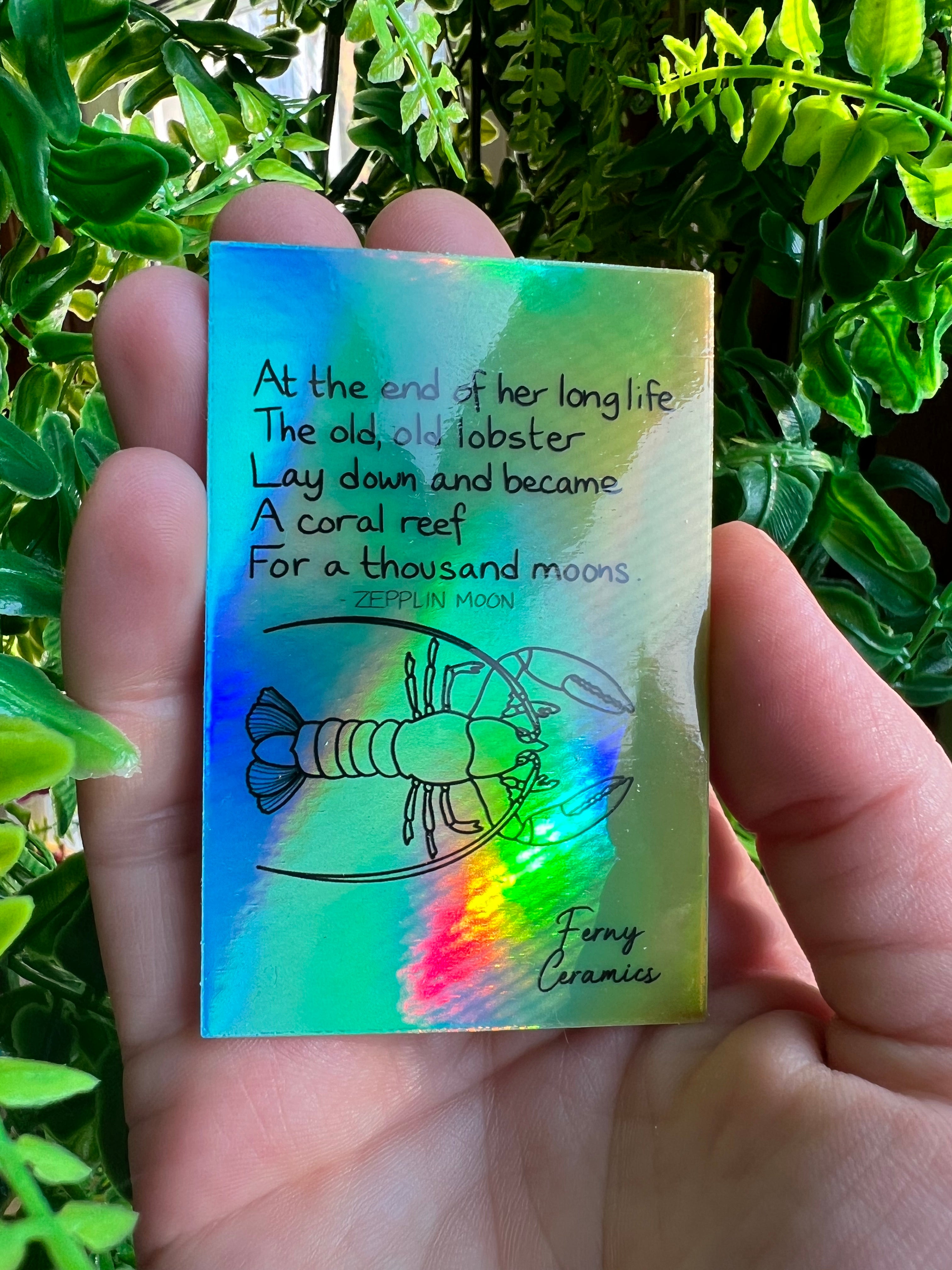 A person is holding a piece of paper with a quote on it, protected by Ferny Ceramics&
