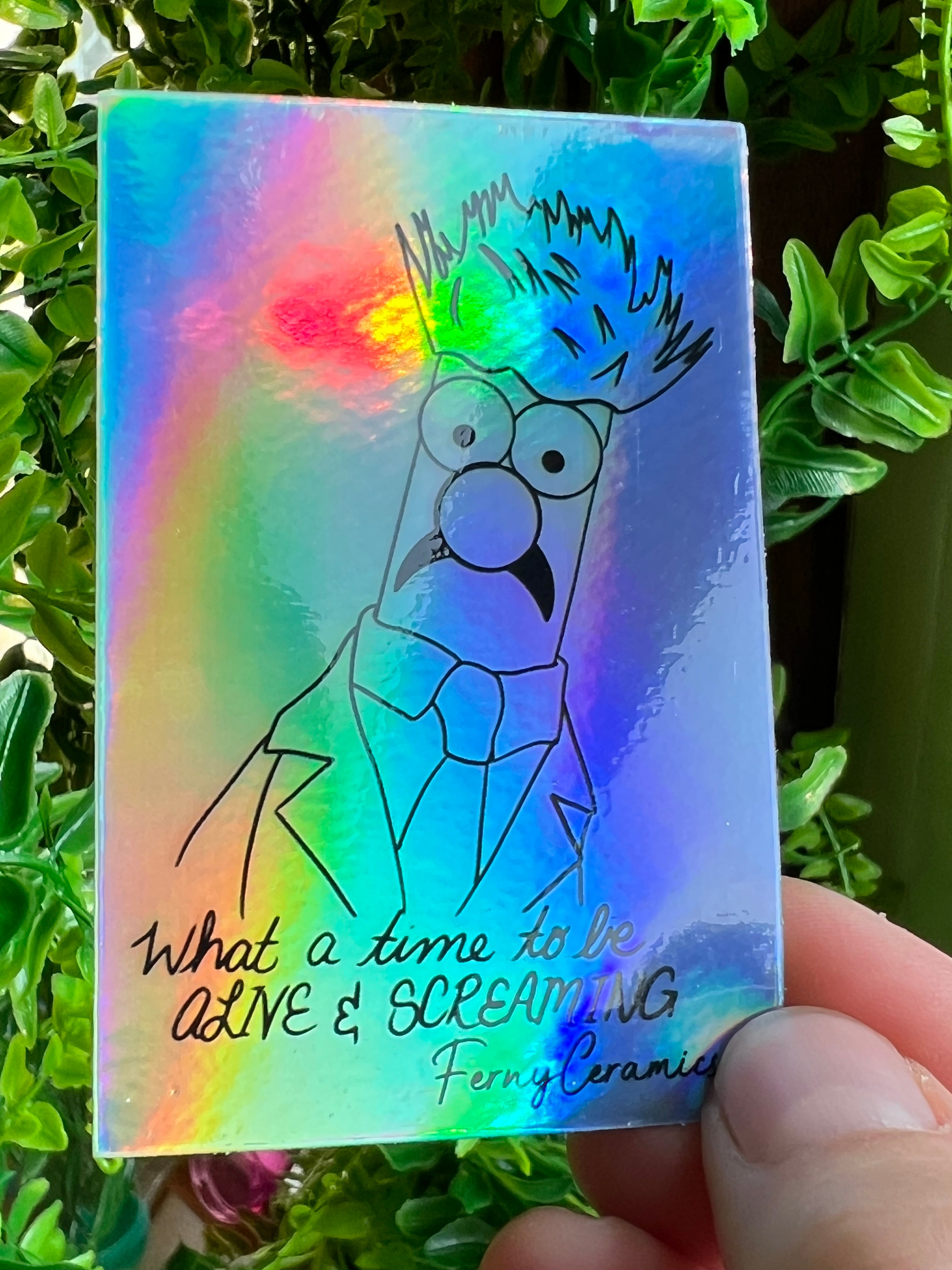 A long-lasting Ferny Ceramics adhesive sticker with a drawing of the Simpsons on 2x3 Rectangular Holographic Stickers.