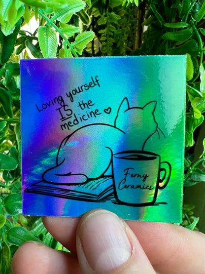 A cat with a cup of coffee is holding a Ferny Ceramics 2x2 Square Holographic Sticker made with high-quality vinyl.